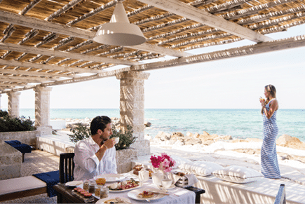 Young couple enjoing breakfast in the  terrace of bedroom110 at La Peschiera in Monopoli